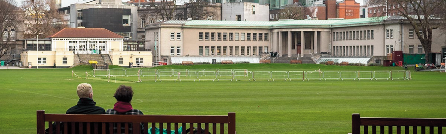 People sitting on benches at Trinity College Dublin